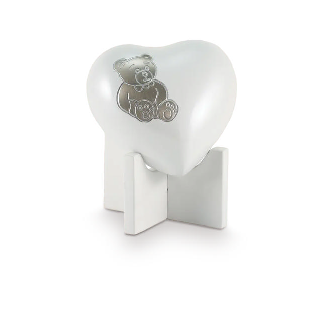 white heart with a bear design on a white stand